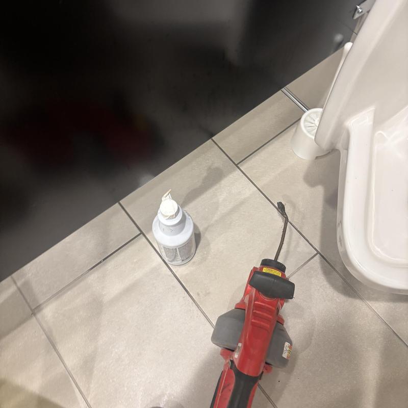 Urinal drain cleaning with cable machine and chemical treatment