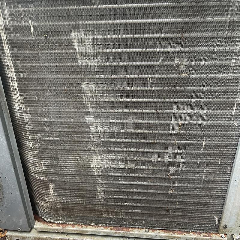 Condenser coil with heavy dirt buildup in HVAC unit