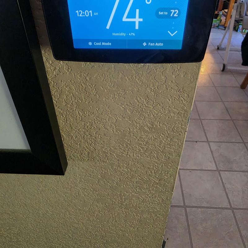 Sensi touchscreen thermostat display on textured wall
