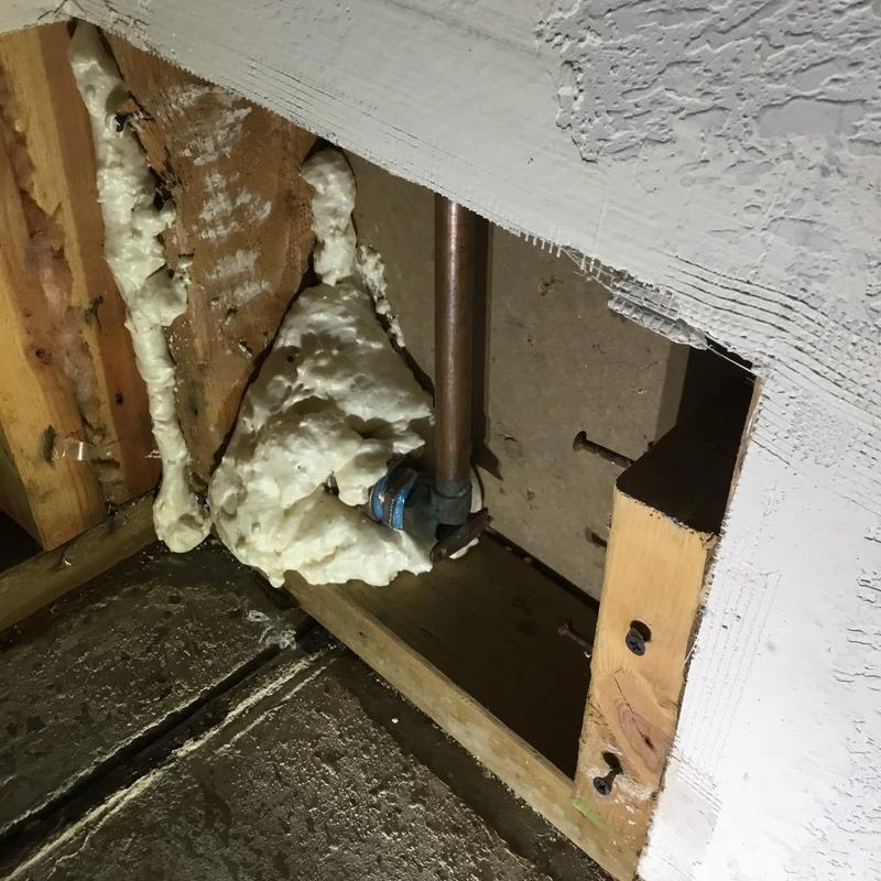 Hose bib pipe with foam insulation in wall cavity
