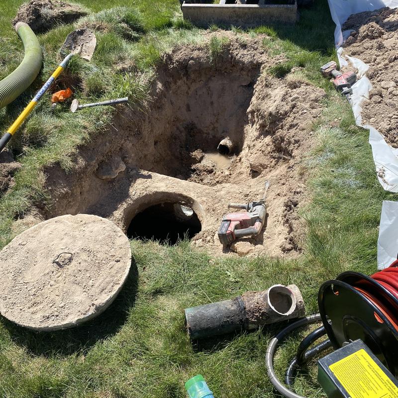 Septic tank excavation with inlet pipe repair tools