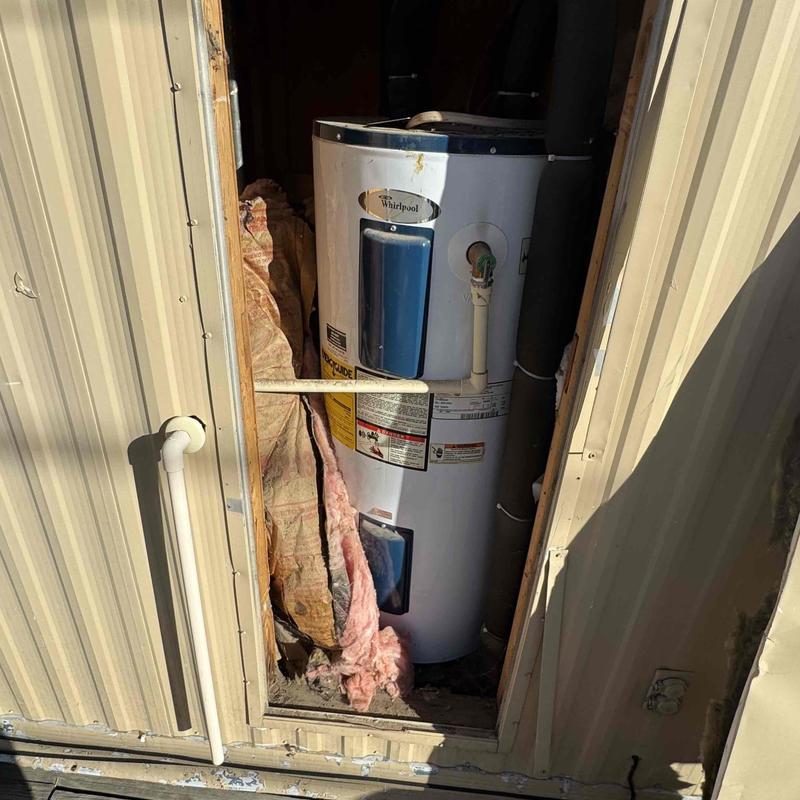 Electric water heater installed behind customized door frame