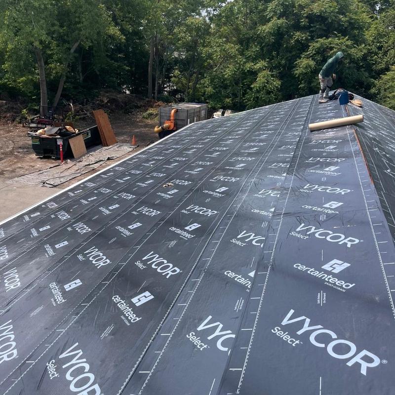Roof underlayment installation on sloped residential roof