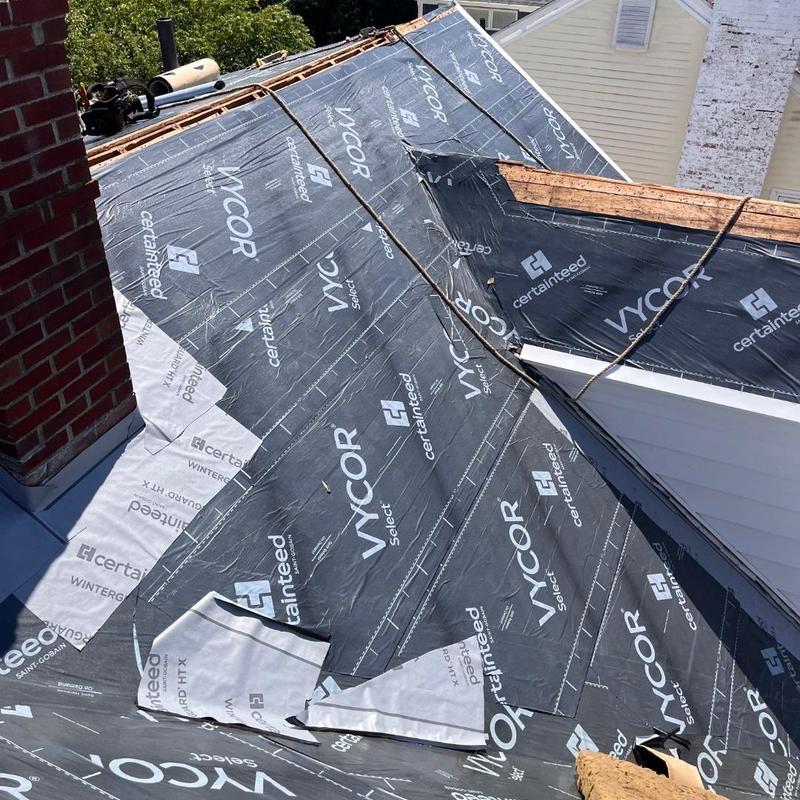 Roof underlayment installation on pitched roof in New London