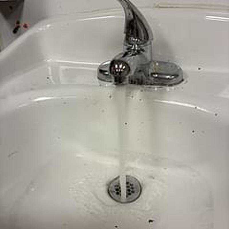 Classroom sink drain with running water Classroom sink drain with running water