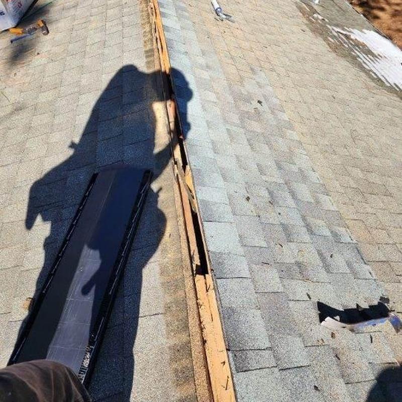 Cabin roof ridge vent removal and shingle repair