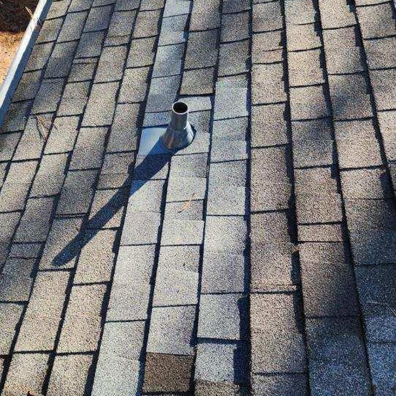 Asphalt shingle roof with metal vent pipe flashing
