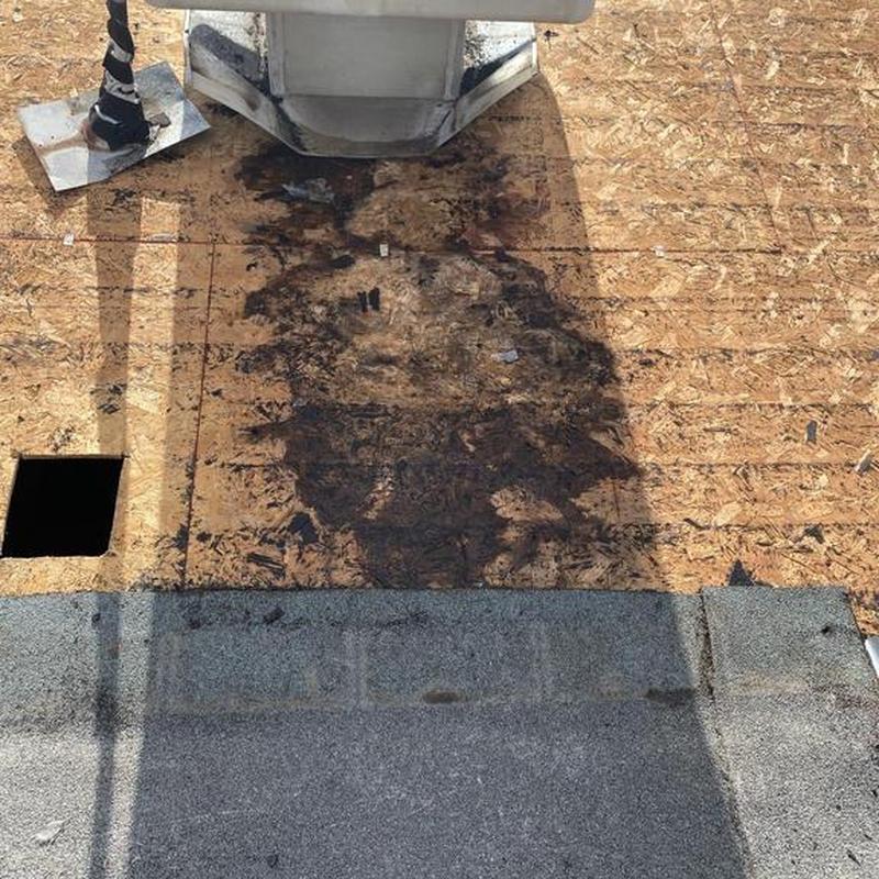 Roof decking with water damage near vent pipe