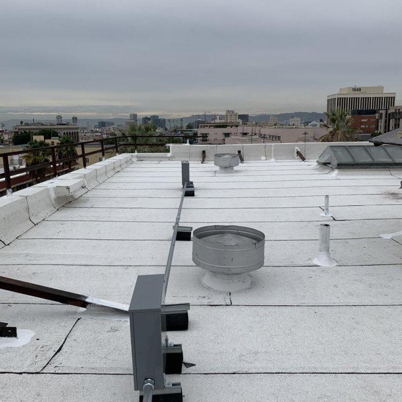 Flat commercial roof with ventilation units and safety rails Flat commercial roof with ventilation units and safety rails
