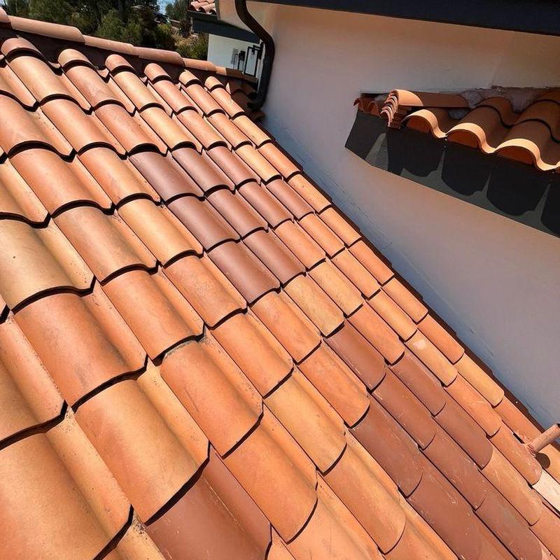 Tile roof with new Spanish-style clay tiles installation Tile roof with new Spanish-style clay tiles installation