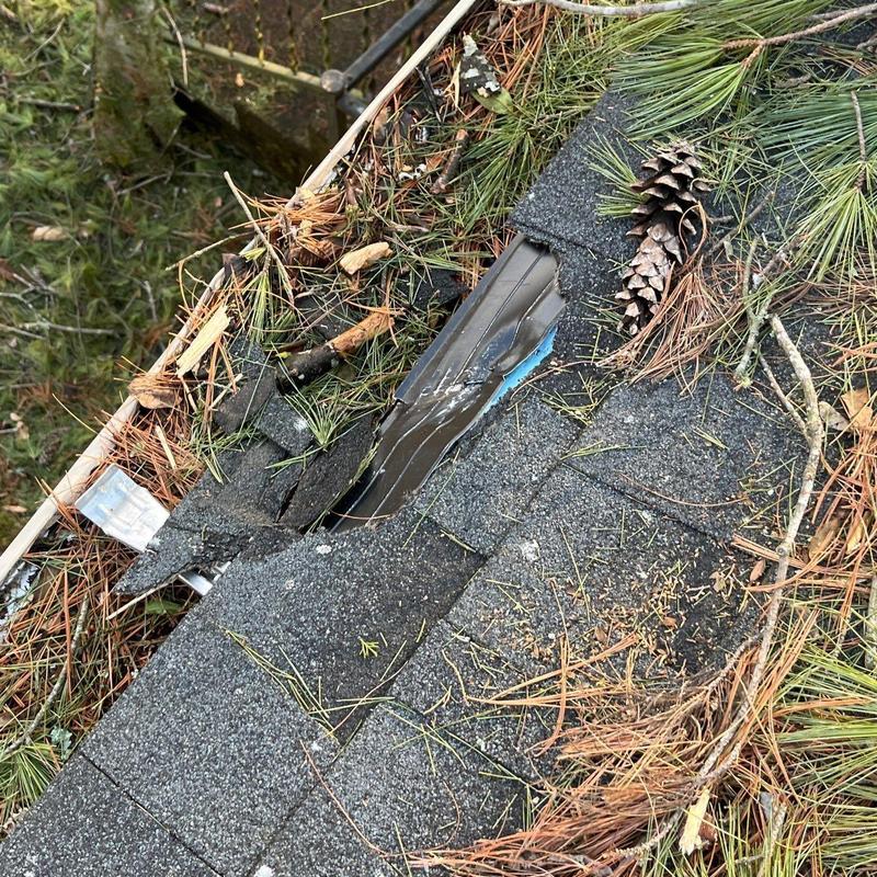 Asphalt Roofing Shingles with Hail Damage and Debris