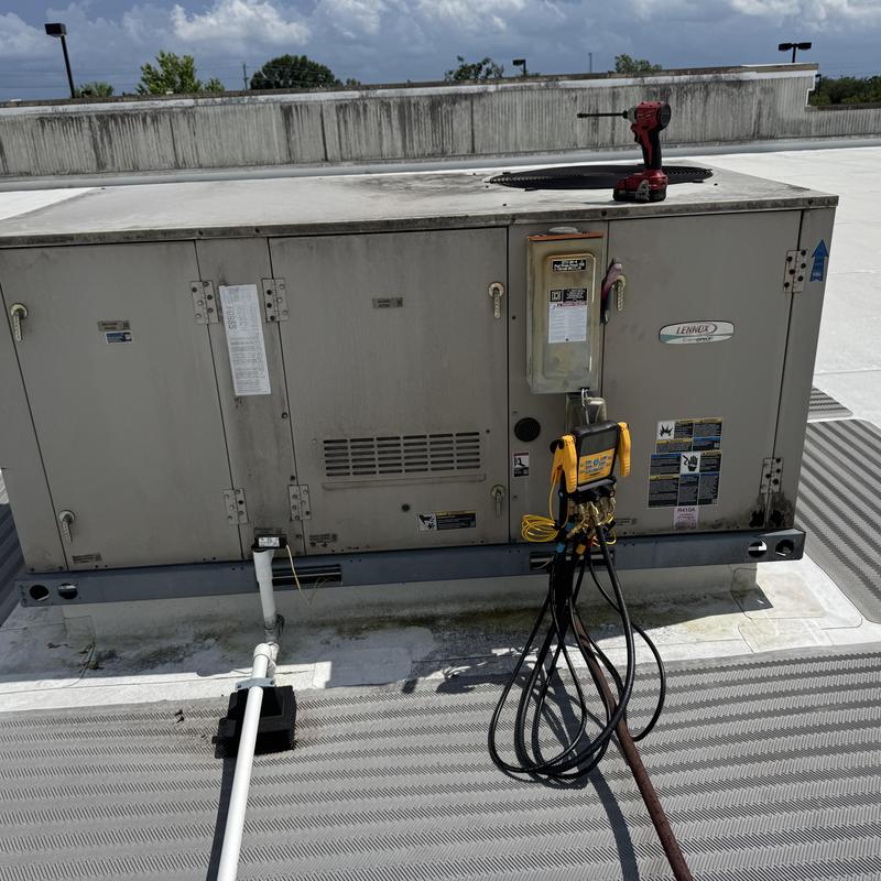 Rooftop HVAC unit with diagnostic gauges and drill