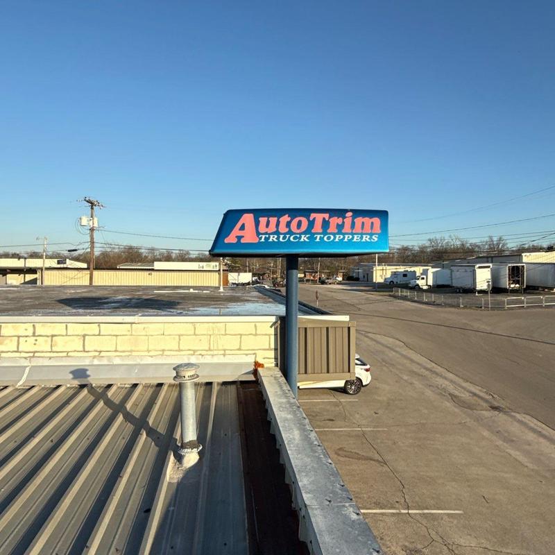 Commercial metal roof with vent pipe and signage