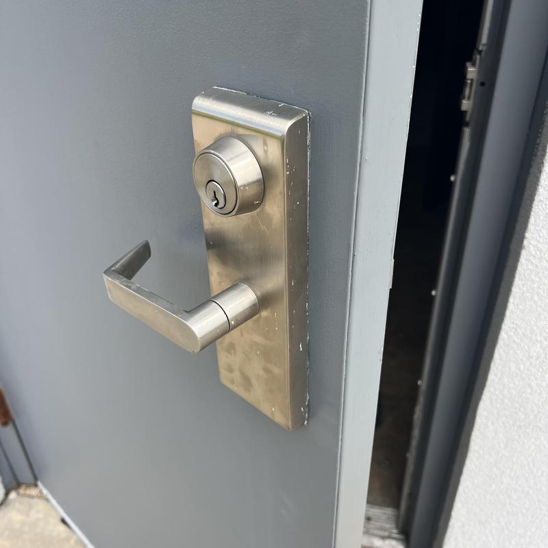 Commercial door lock with handle on gray door