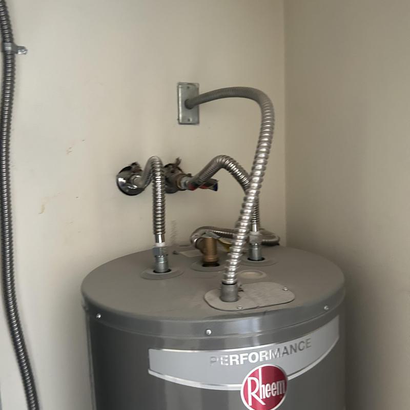 Water heater with flexible gas and water lines connected