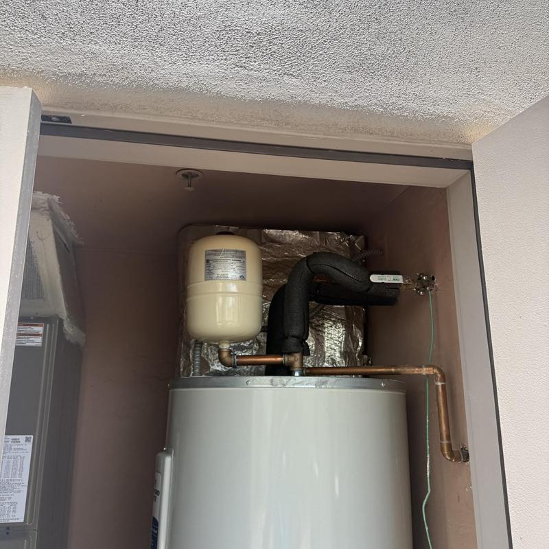Expansion tank and water heater piping in closet
