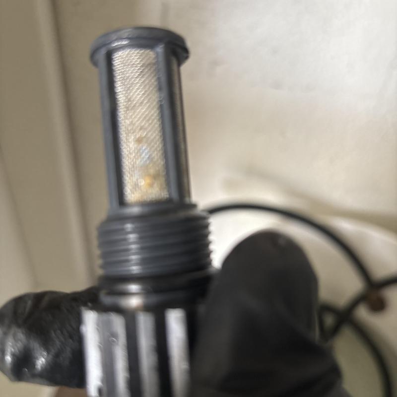 Tankless water heater P-trap drain screen cleaning