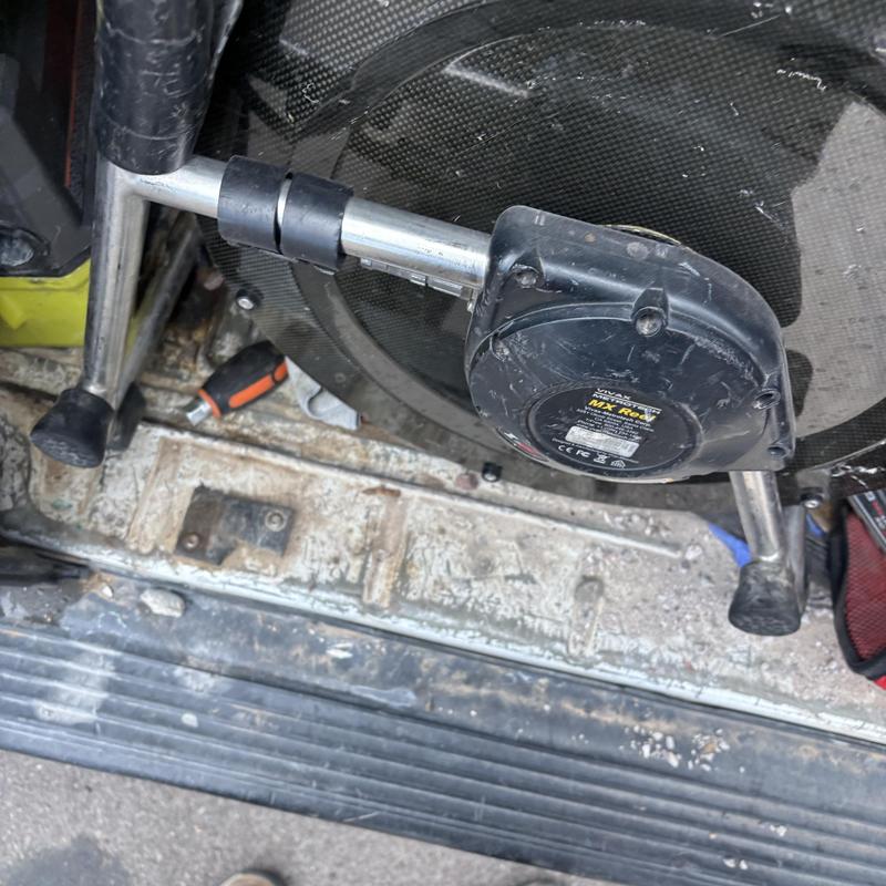 Drain cleaning machine hose reel on van floor
