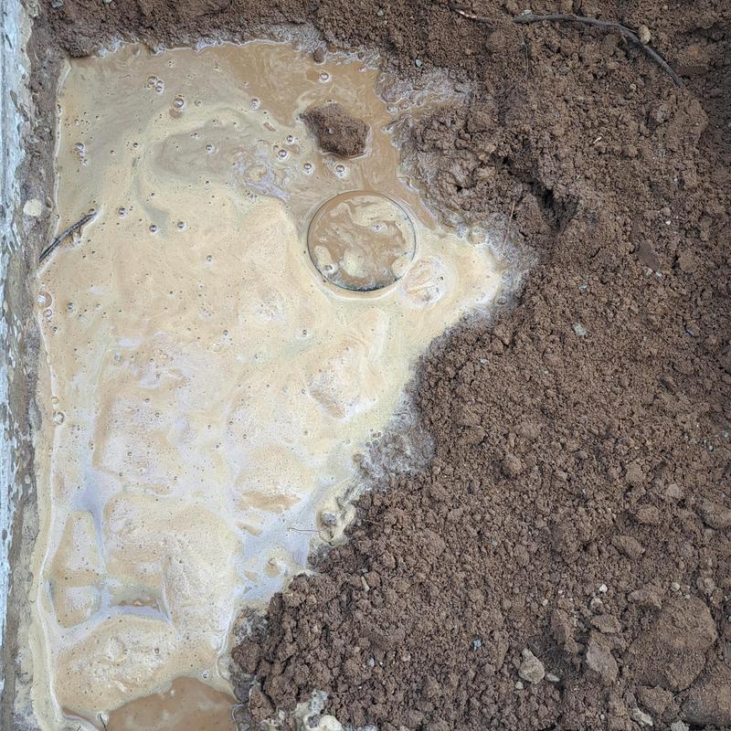 Sewer line bubble leak with surrounding soil dirt Sewer line bubble leak with surrounding soil dirt