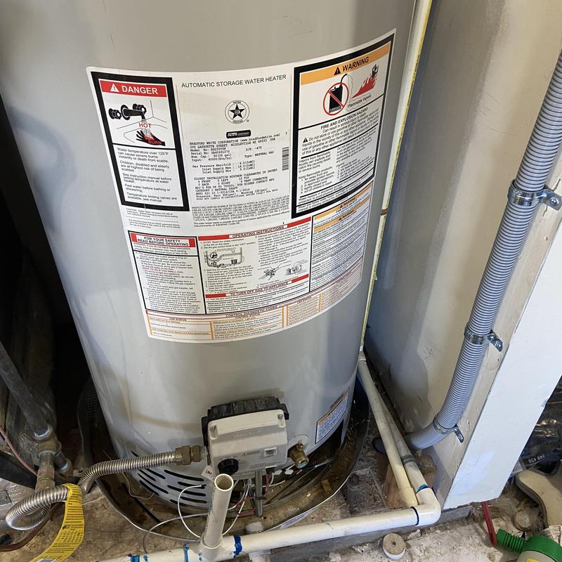 Water heater installation with piping and controls