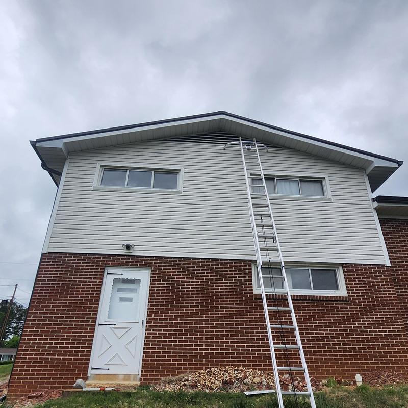 Soffit damage repair with ladder on residential home