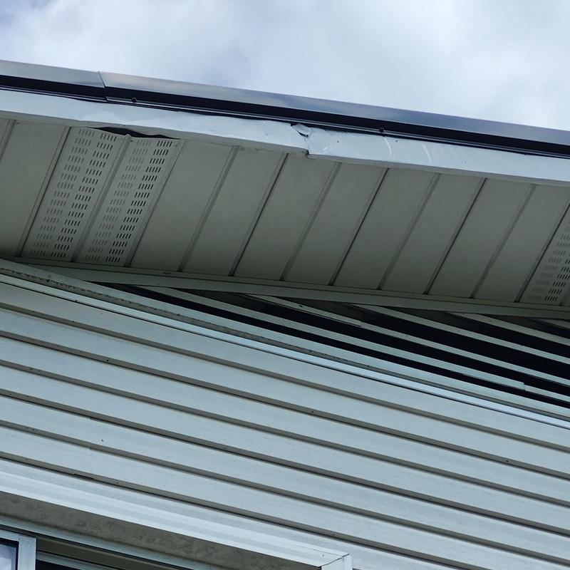 Damaged soffit panel on house roof edge