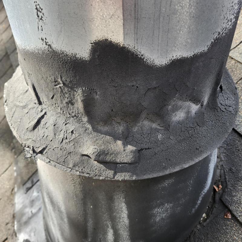 Chimney flashing with cracked sealant and damage