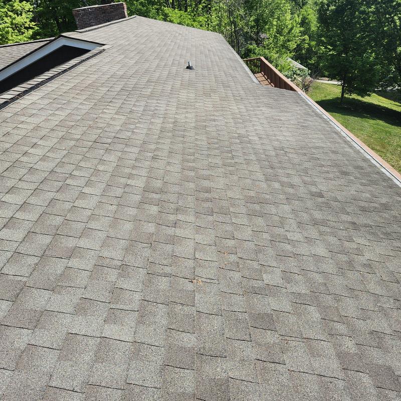 Roof shingle surface with vent pipe and chimney collar