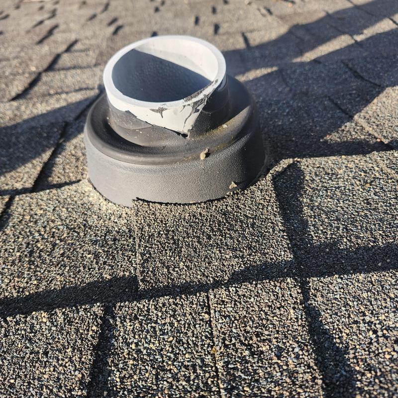 Roof vent collar with cracked seal on shingle roof