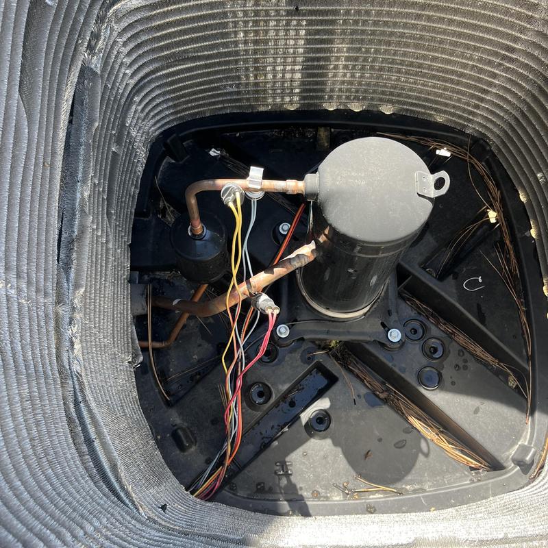 Air conditioner compressor with wiring inside coil housing Air conditioner compressor with wiring inside coil housing
