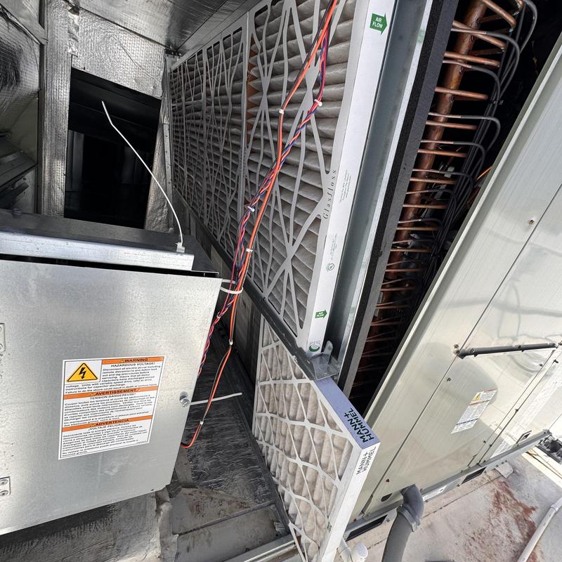 RTU air filters installation with electrical panel nearby