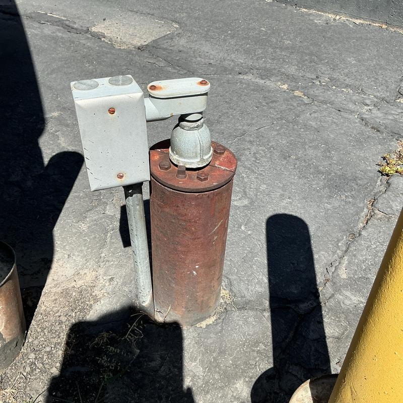 Well pump pressure switch with control box on pavement Well pump pressure switch with control box on pavement