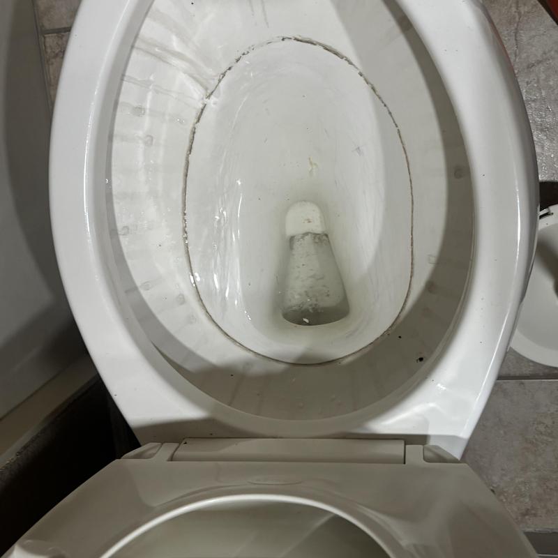 Toilet bowl with water stains and grime buildup