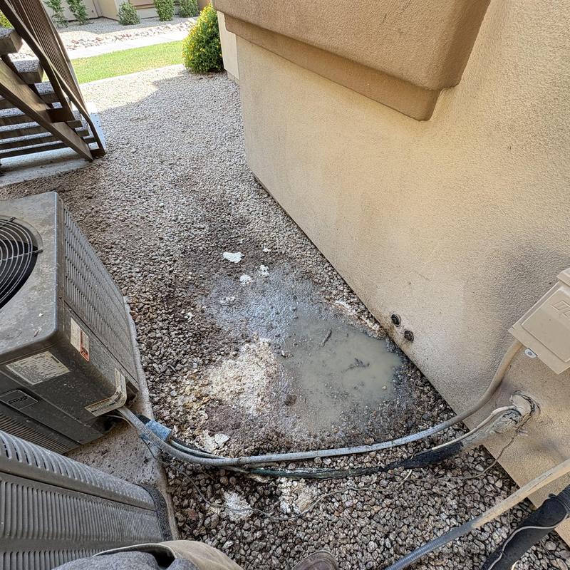 Leaking exterior water line near AC units with pooling water