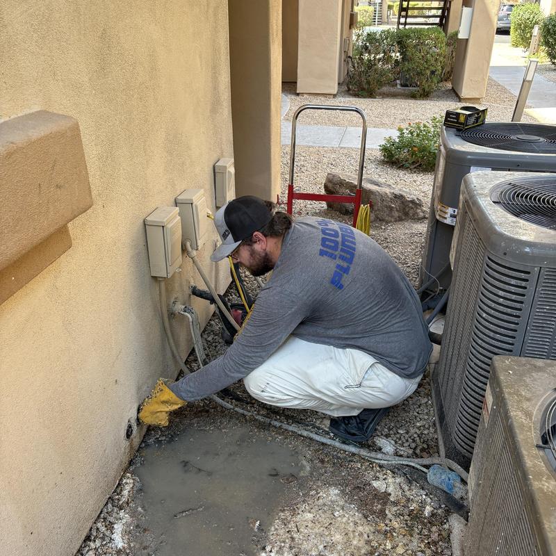 Exterior water line leak near air conditioning units repair