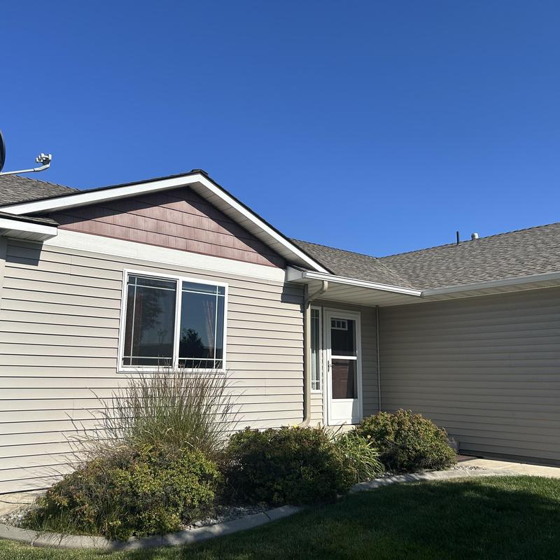 Asphalt shingle roof and gutter system on home exterior Asphalt shingle roof and gutter system on home exterior