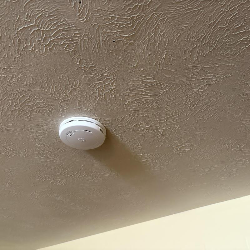 Smoke detector installed on household ceiling Smoke detector installed on household ceiling