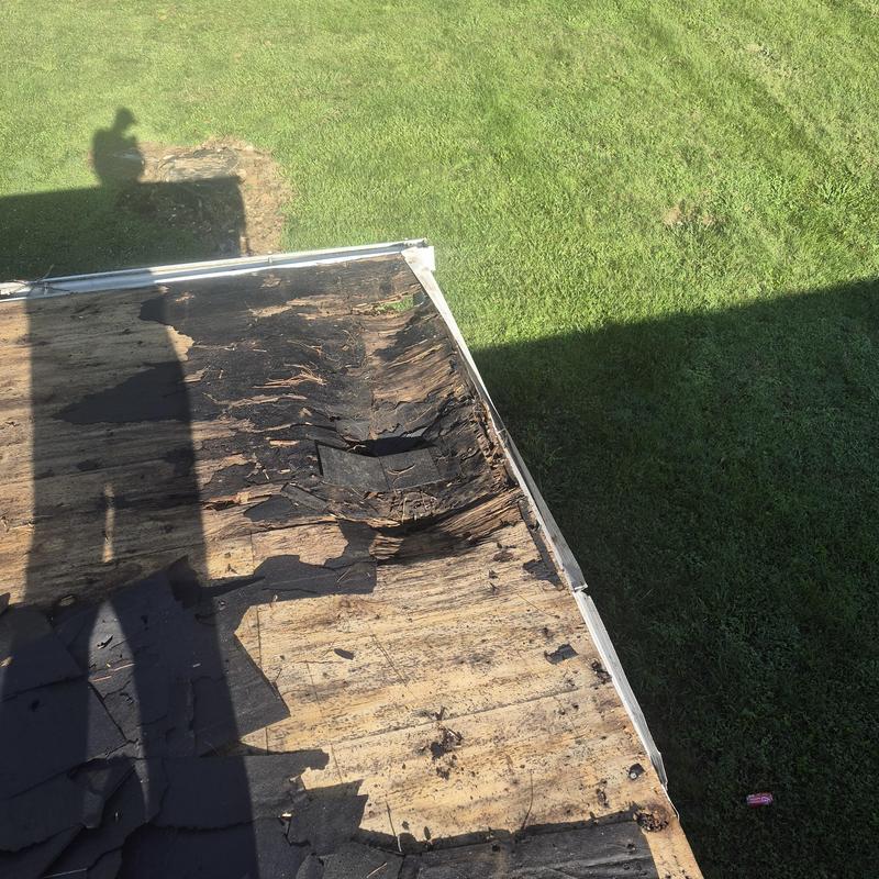 Roof decking removal and inspection with damaged wood visible
