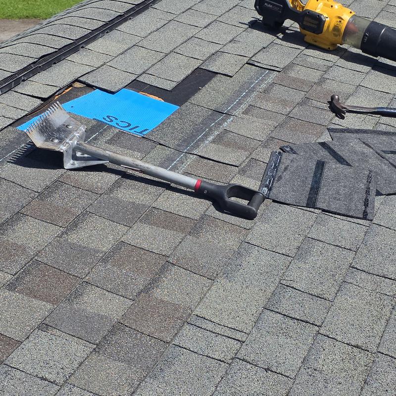 Asphalt roof shingles with repair tools and materials