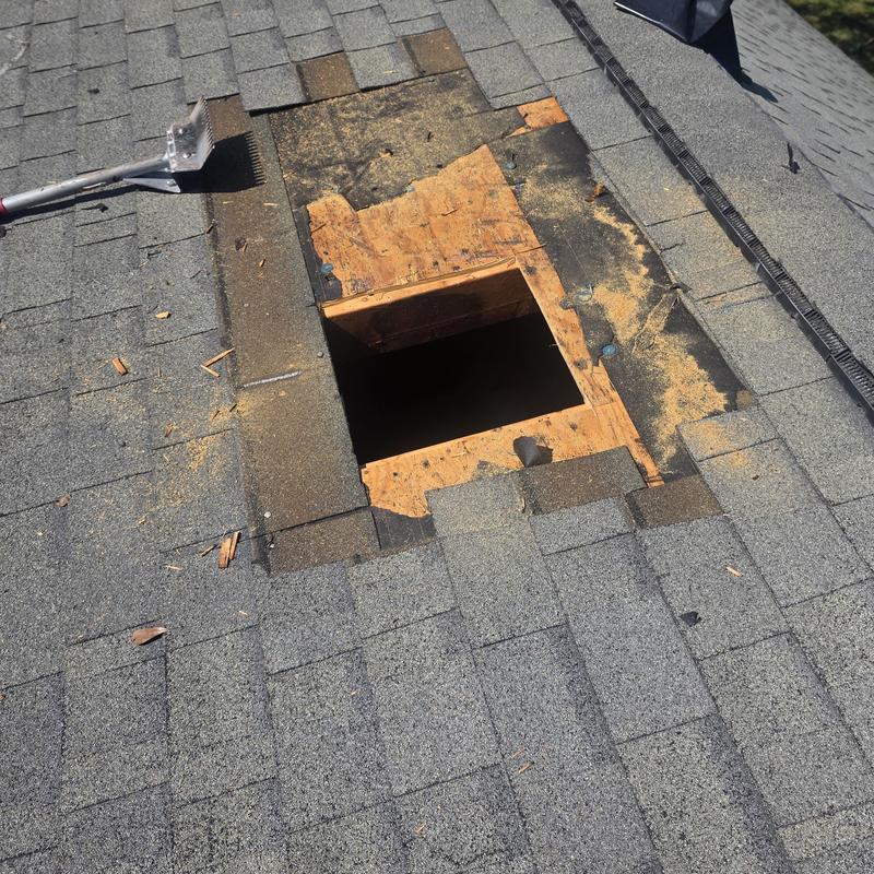 Roof decking exposed after turbine vent removal on shingle roof