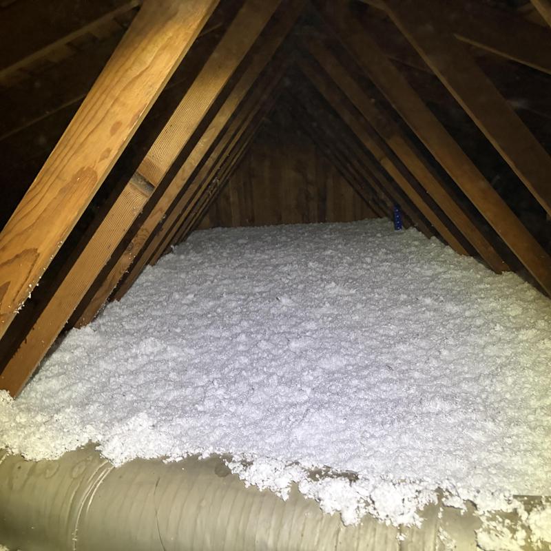 Attic floor with newly installed loose-fill insulation