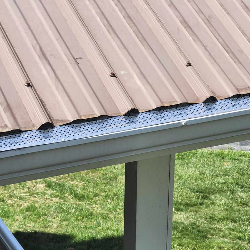 Metal roof panel screws replaced on bottom row