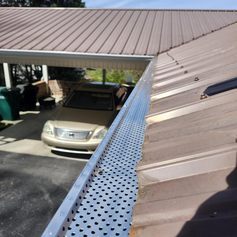 Metal roof bottom row screw replacement and gutter guard installation