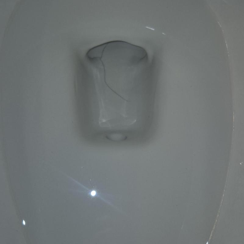 Toilet bowl with visible crack inside water reservoir area