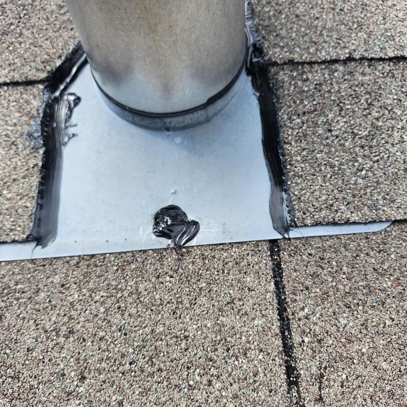 Roof vent flashing with new sealant on shingle roof