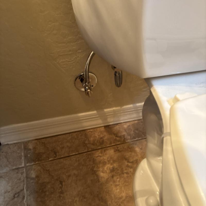 Quarter turn angle stop valve next to toilet tank