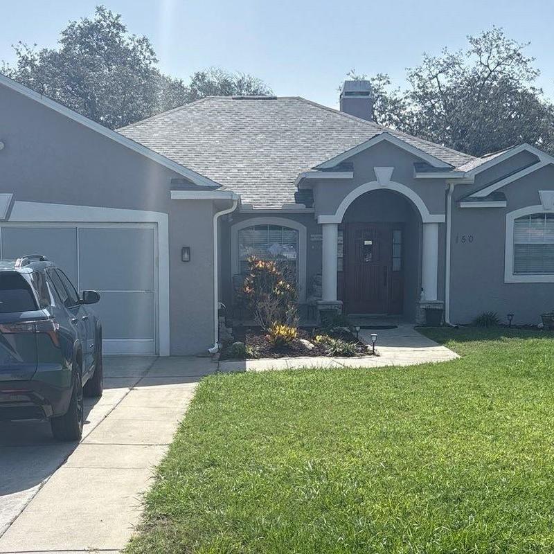 Asphalt shingle roof with intact gutters on home