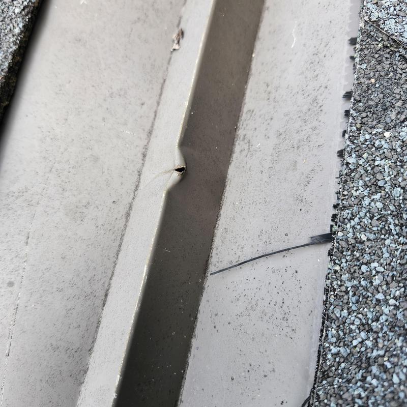 Metal roof flashing with a puncture near shingles