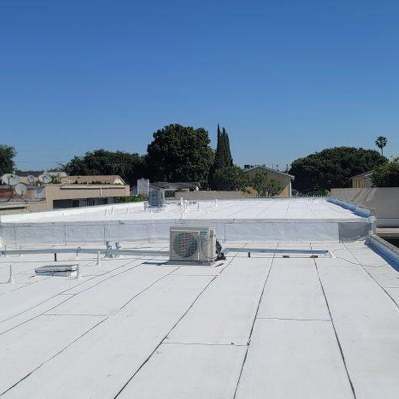 Commercial flat roof with HVAC unit and vent pipes Commercial flat roof with HVAC unit and vent pipes
