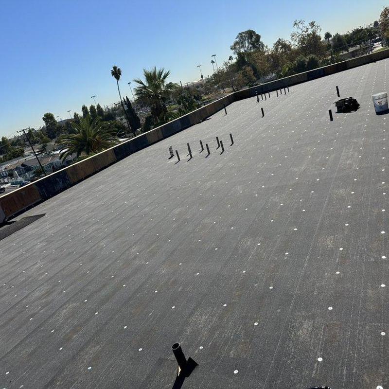 Flat roof membrane with pipe installations and fasteners Flat roof membrane with pipe installations and fasteners